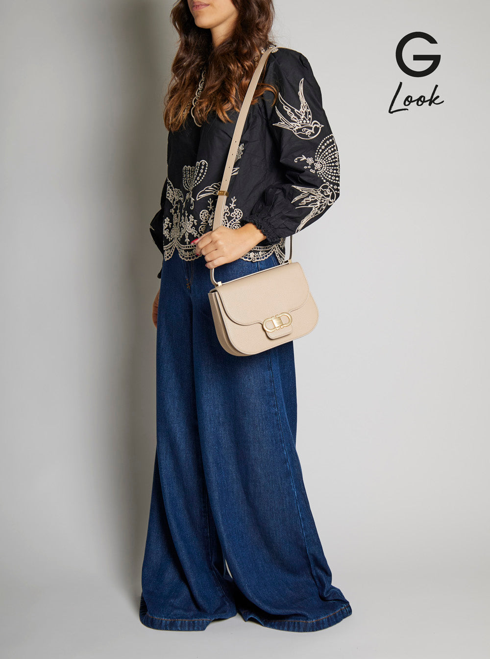 Bolsa de ombro feminina Ferragamo bege com detalhe Gancini metálico na frente em couro martelado.